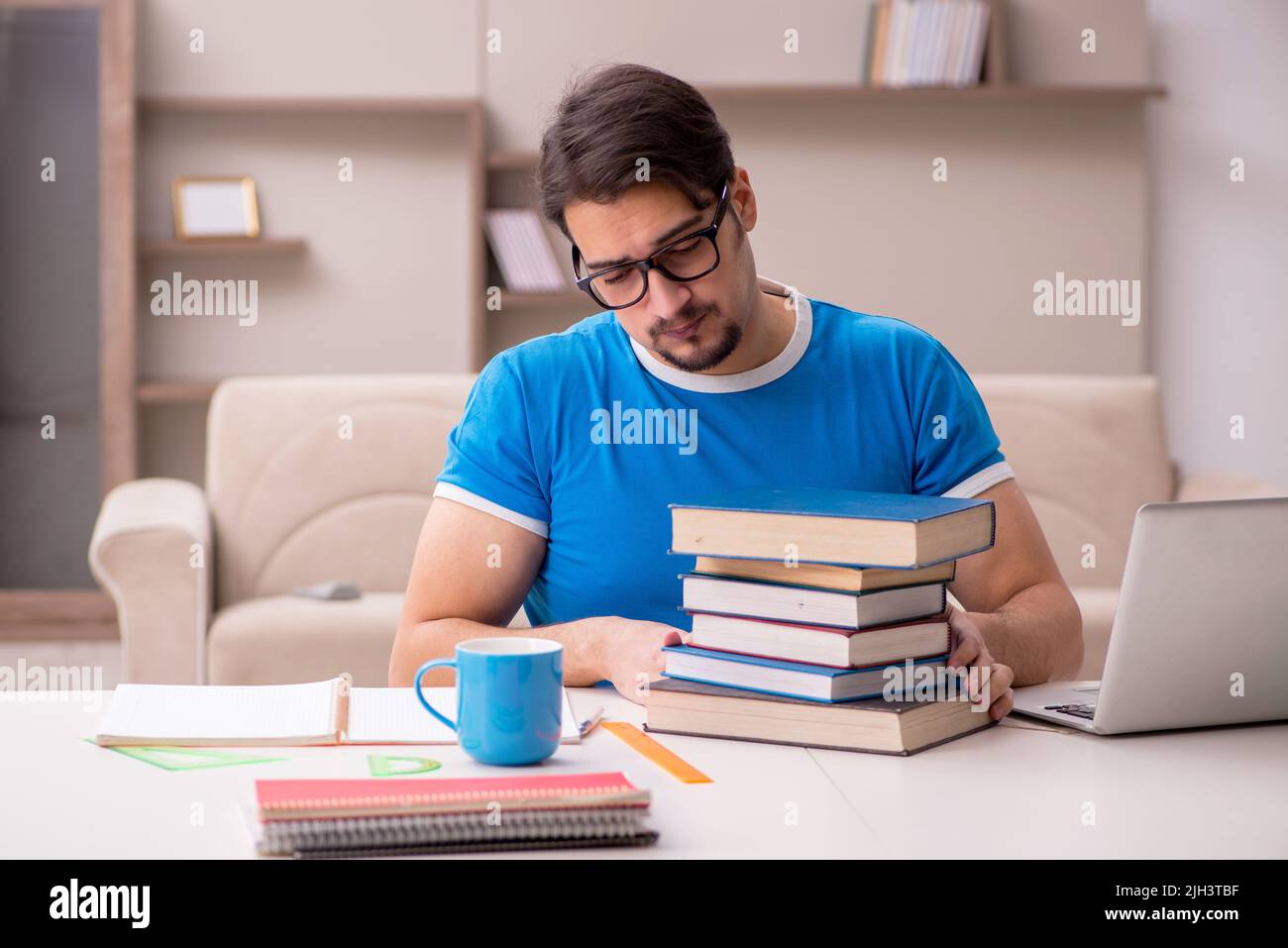 Young student studying at home Stock Photo - Alamy