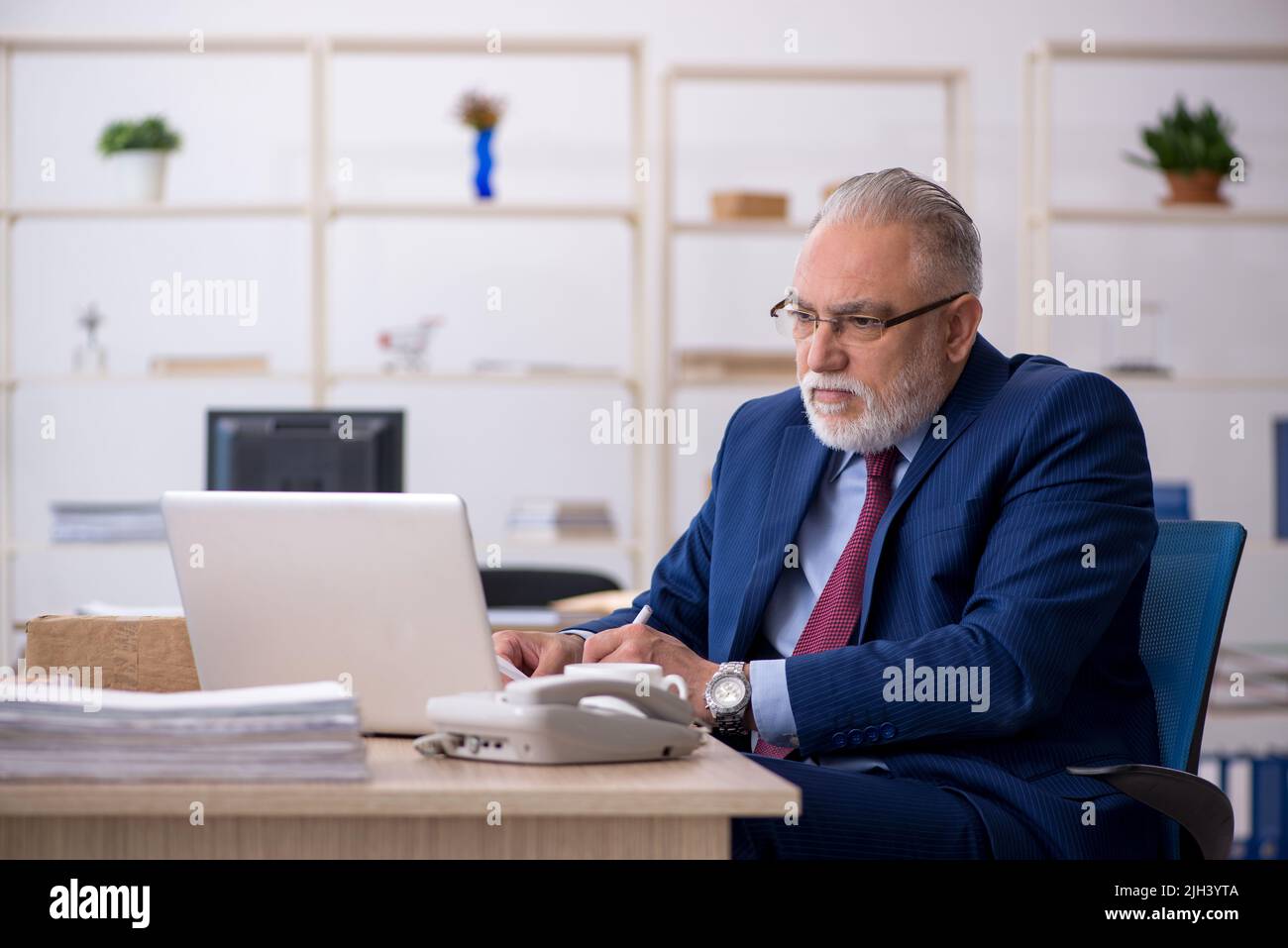 Old businessman employee working at workplace Stock Photo - Alamy
