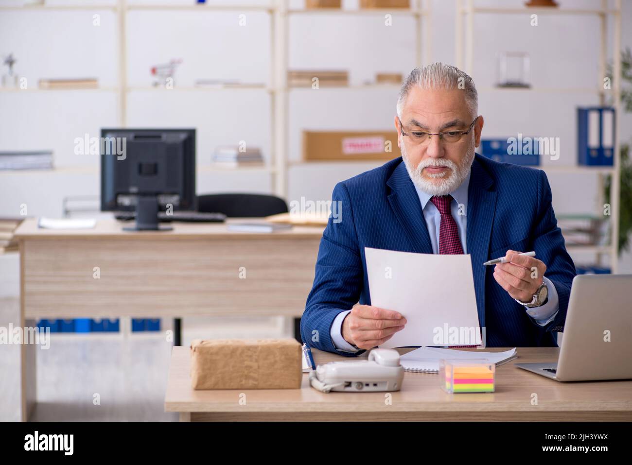 Old businessman employee working at workplace Stock Photo - Alamy