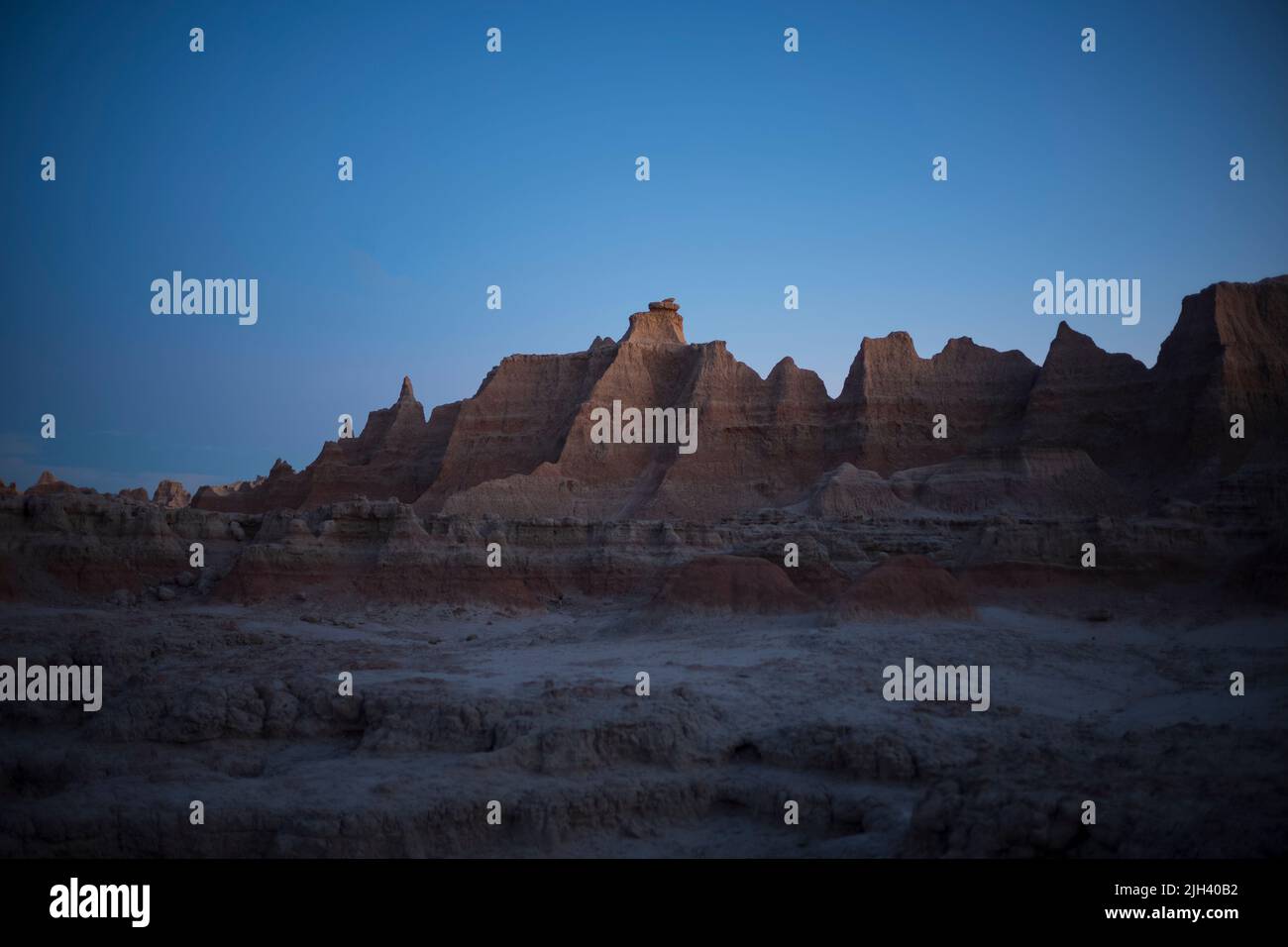 A view of a sunset along the Door Trail at Badlands National Park in South Dakota. Stock Photo