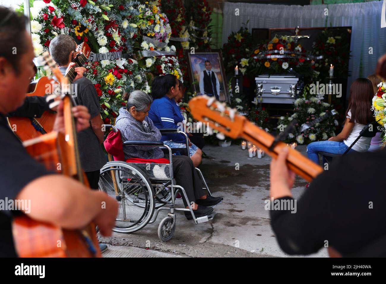 Relatives and friends of late migrant Jose Lopez, 34, attend his wake after being repatriated from San Antonio, Texas, U.S., at his family's home in Celaya, in Guanajuato state, Mexico July 14, 2022. REUTERS/Edgard Garrido Stock Photo