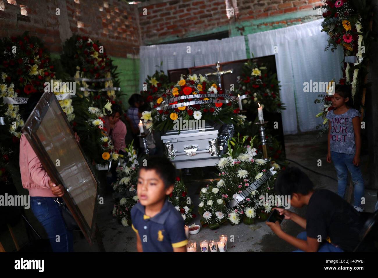 Relatives and friends of late migrant Jose Lopez, 34, attend his wake after being repatriated from San Antonio, Texas, U.S., at his family's home in Celaya, in Guanajuato state, Mexico July 14, 2022. REUTERS/Edgard Garrido Stock Photo