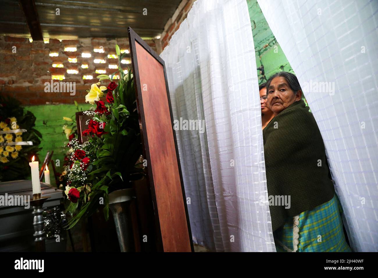 A woman looks on during the wake of the late migrant Jose Lopez, 34, after being repatriated from San Antonio, Texas, U.S., at his family's home in Celaya, in Guanajuato state, Mexico July 14, 2022. REUTERS/Edgard Garrido Stock Photo
