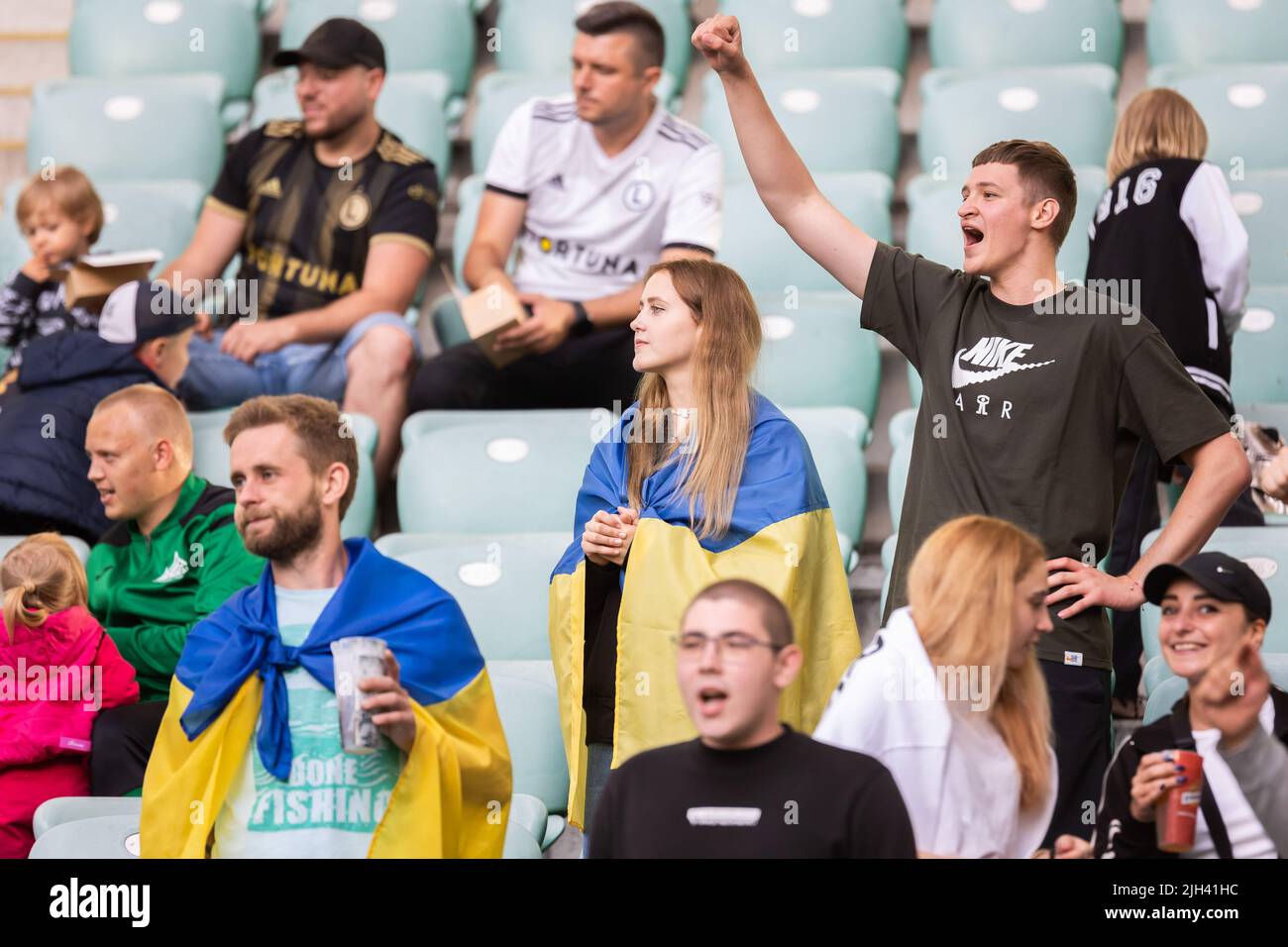 Fans with Ukrainian flags seen during the friendly match between Legia ...