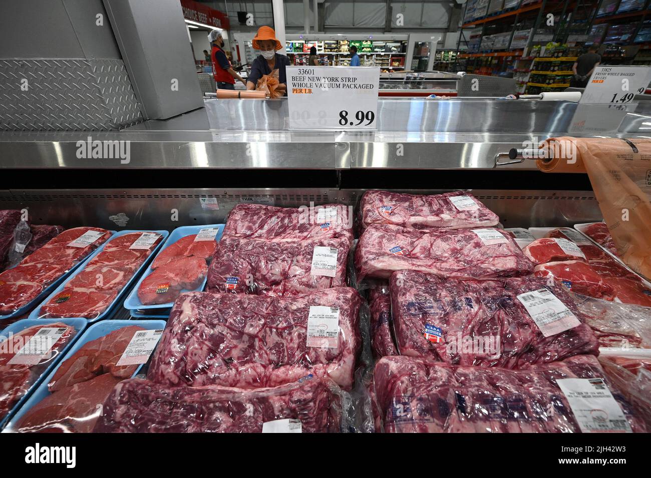 New York, USA. 14th July, 2022. People are seen shopping in the meat section of a Costco wholesale store as news of inflation surging to 9.1% in the month of June is reported, in the Queens borough of New York City, NY, July 14, 2022. The highest surge since 1981, inflation is being led by higher gasoline prices, up 59.1%, airfares up 34.1% and household energy up 21.9%. (Photo by Anthony Behar/Sipa USA) Credit: Sipa USA/Alamy Live News Stock Photo