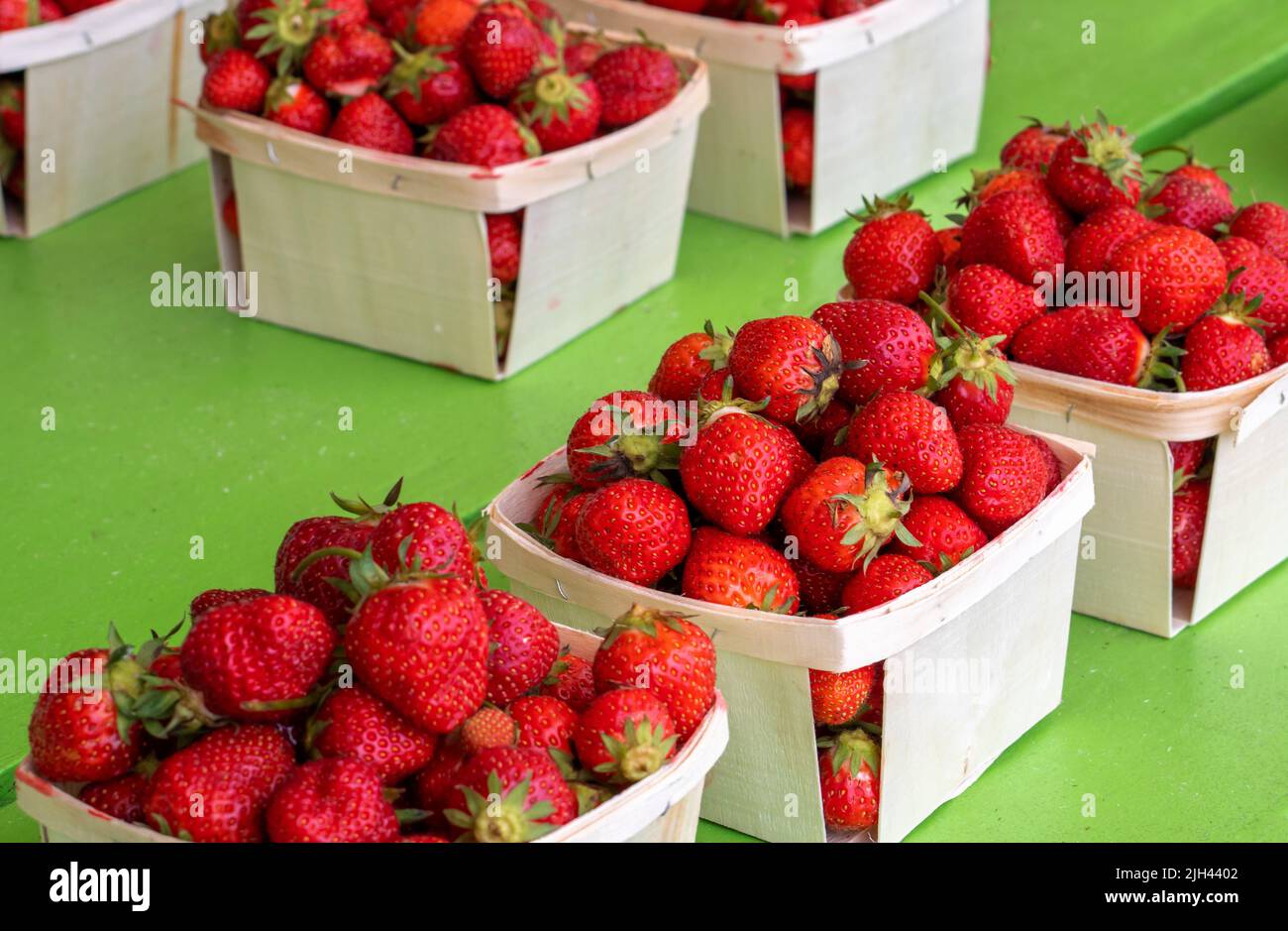 pints of ripe red strawberries sit for sale at a fruit stand in Michigan USA Stock Photo