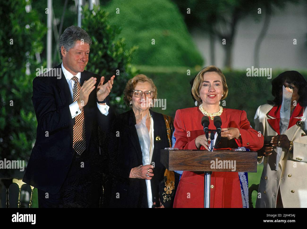 WASHINGTON DC - MAY 6, 1994 President Bill Clinton applauds his wife First Lady Hillary Rodham Clinton as she addresses the crowd under a tent in the Rose Garden during a Mothers Day event regarding WomenÕs Health Issues. Louise DeLauro the mother of Congresswoman Rosa Delauro (D-CT) is seen standing behind the Clintons Stock Photo