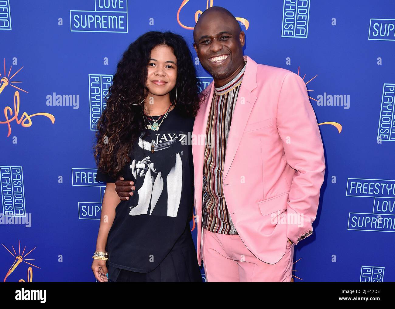 Maile Masako Brady and Wayne Brady walking on the red carpet at the