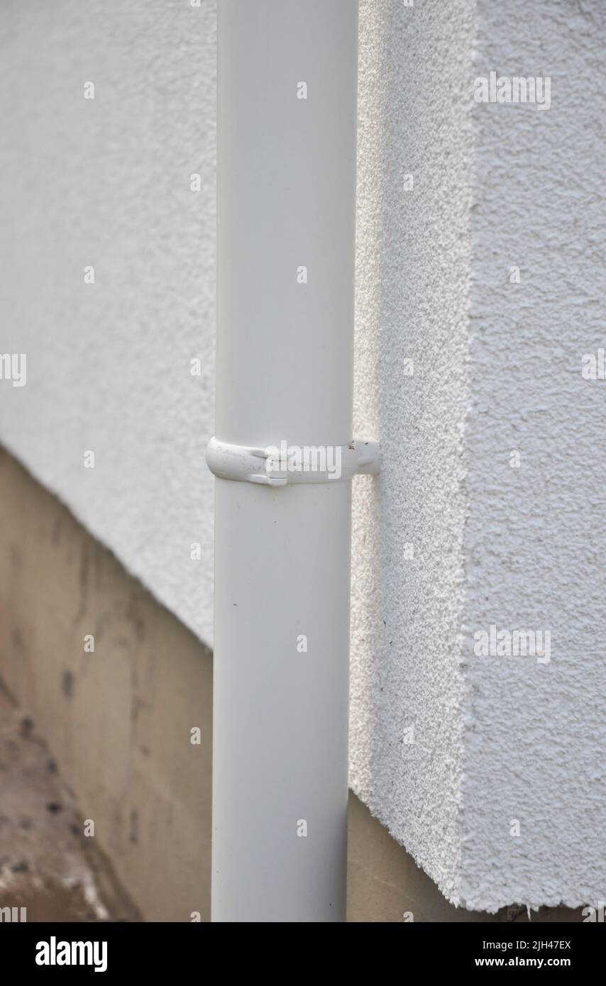 Close up on roof gutter downspout pipe holder on the house facade wall