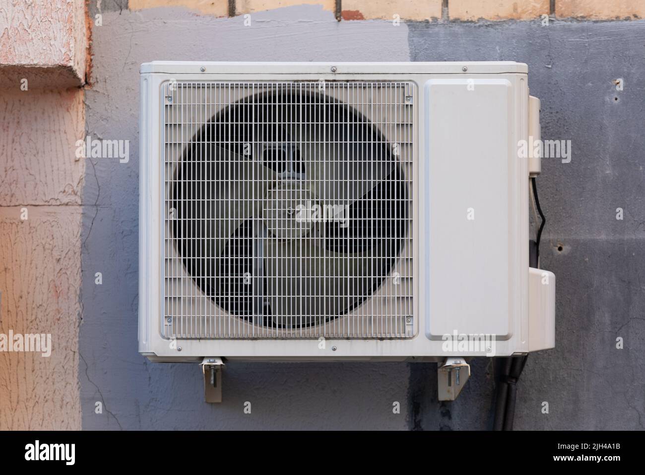 outdoor air conditioner unit on the wall of a building Stock Photo - Alamy