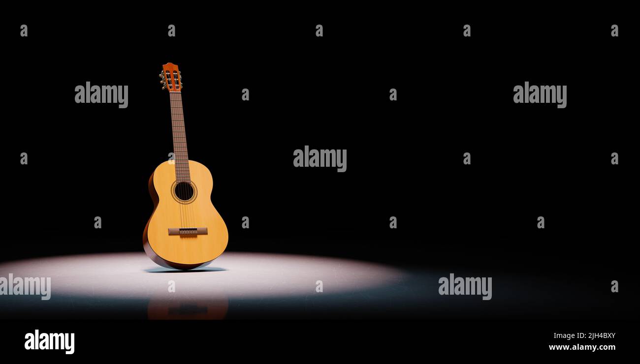 Classical Guitar Spotlighted on Black Background Stock Photo