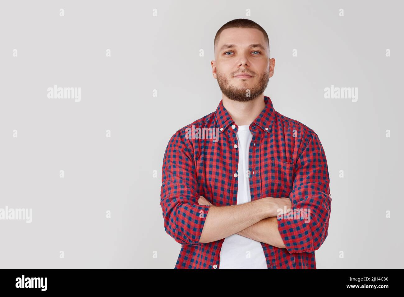smiling young guy posing with crossed arms Stock Photo - Alamy