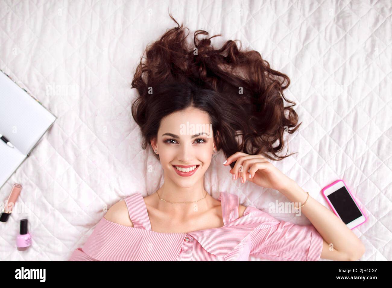 Beautiful woman lying on bed top view Stock Photo