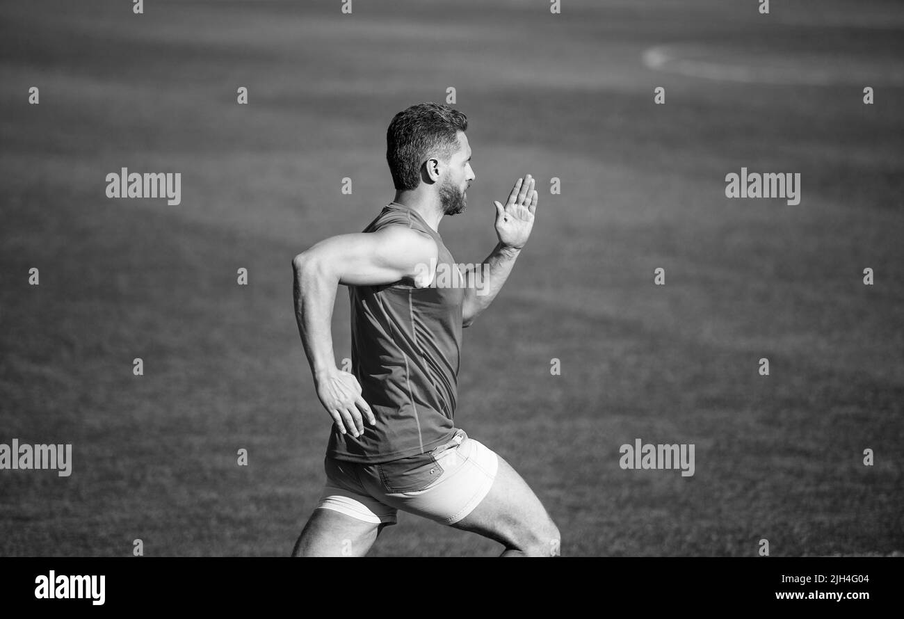 sportsman man in sportswear run fast sprinting on running track, endurance Stock Photo