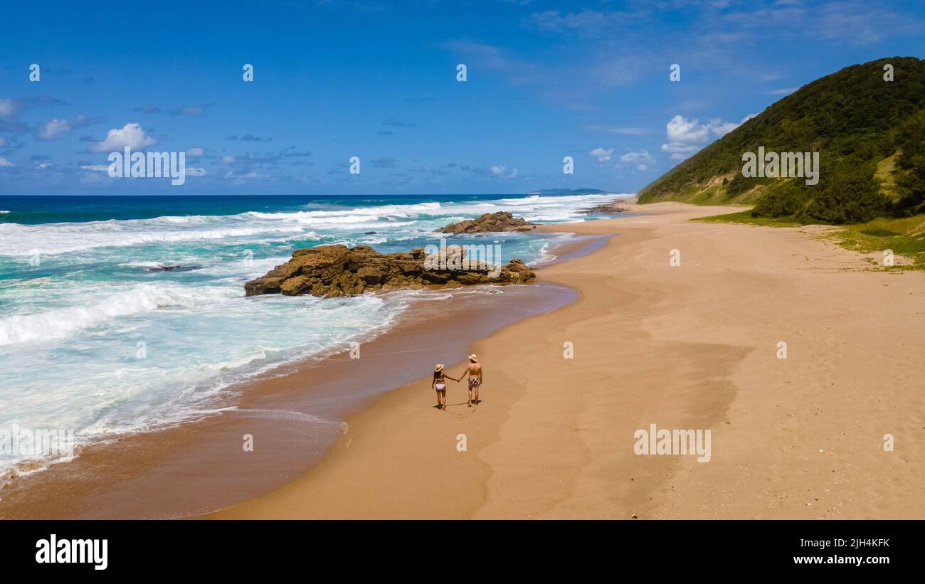St Lucia South Africa, men and woman walking at the beach Mission Rocks beach near Cape Vidal in Isimangaliso Wetland Park in Zululand. South Africa St Lucia Stock Photo