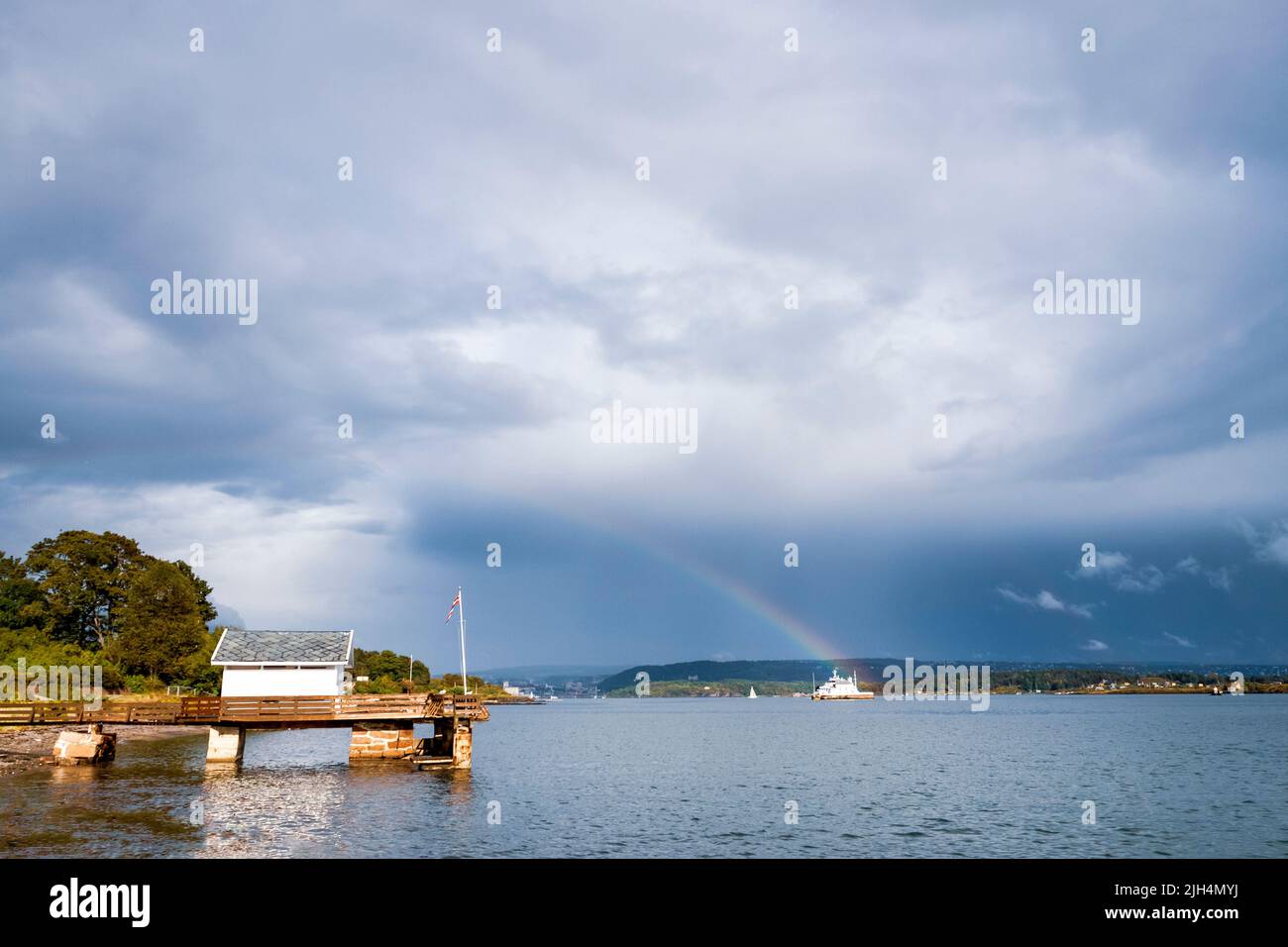 Oslofjord after the storm remains the rainbow. Oslo, Ostlandet. Norway Stock Photo