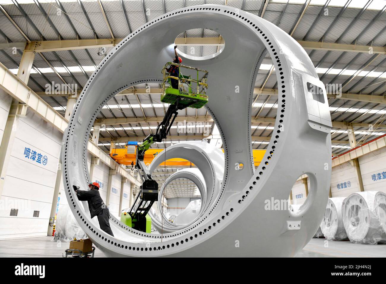 Beijing, China's Shandong Province. 7th June, 2022. Staff members work at the painting workshop for hubs of wind turbine in Huimin County, east China's Shandong Province, June 7, 2022. Credit: Guo Xulei/Xinhua/Alamy Live News Stock Photo