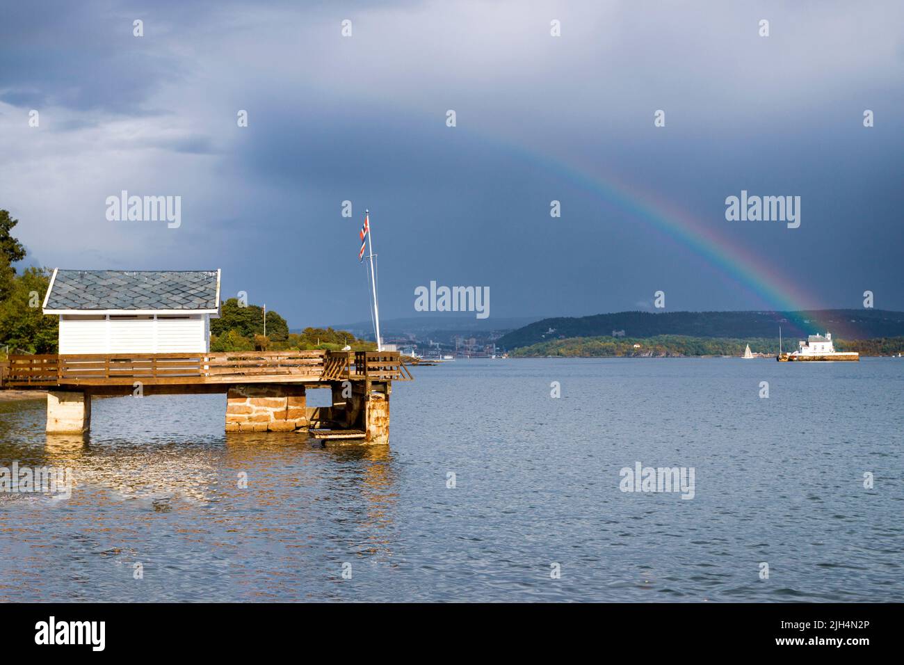 Oslofjord after the storm remains the rainbow. Oslo, Ostlandet. Norway Stock Photo