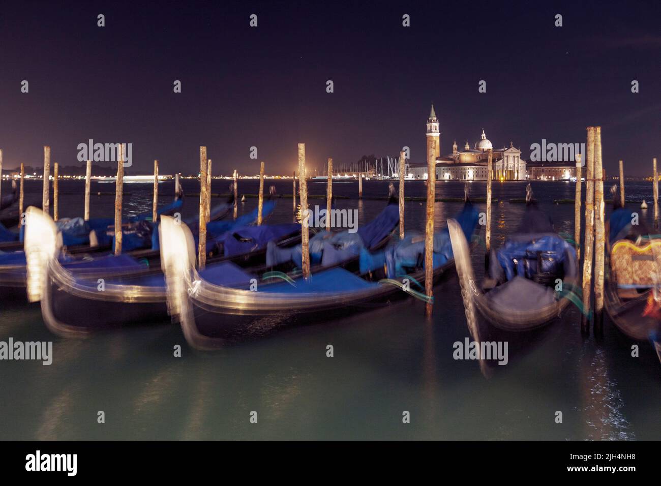 Long exposition on gondolas docked in lagoon. Venice, Veneto. Italy Stock Photo