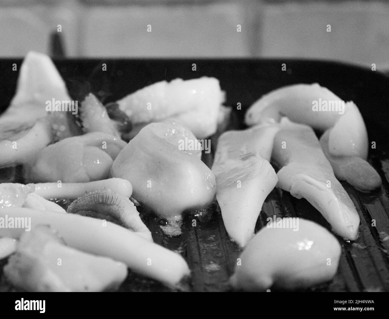 grilling a raw adriatic cuttlefish at home in Numana, Marche, Italy Stock Photo