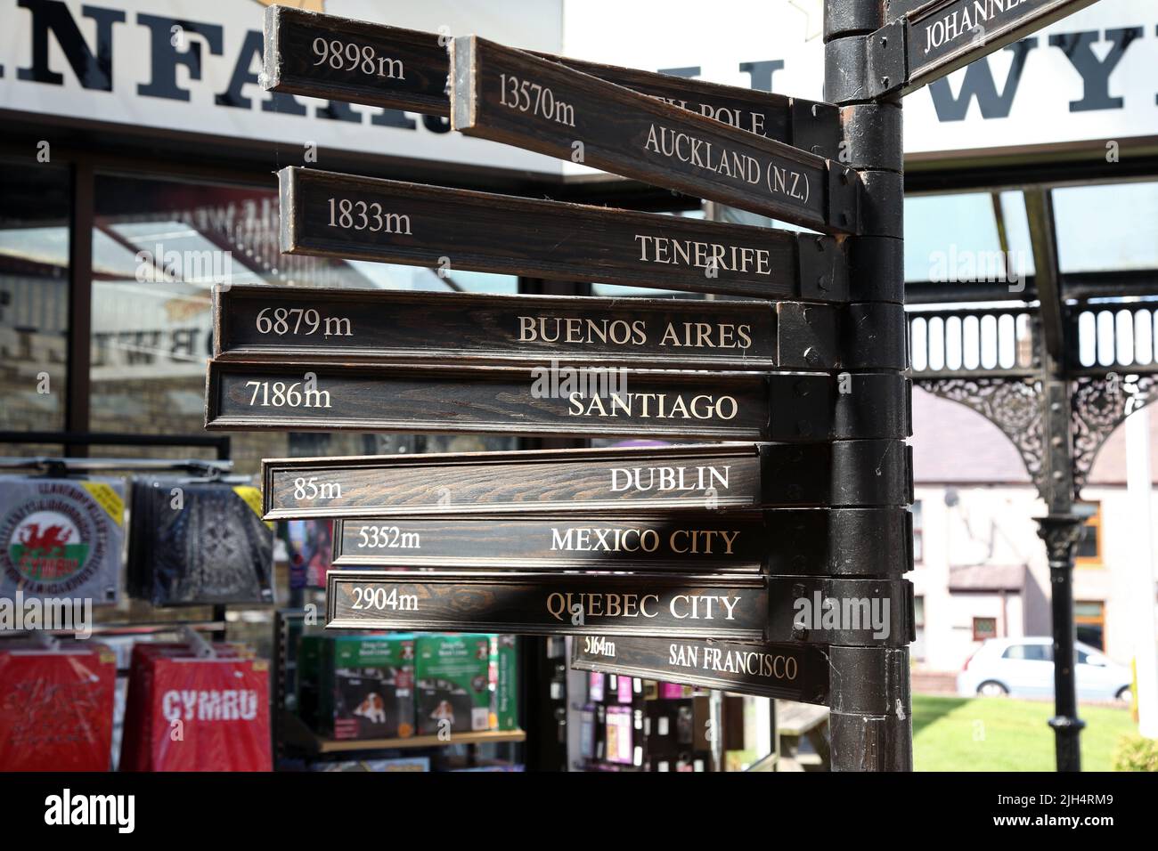 Signpost of cities of the world at Llanfair PG (longest place name), Anglesey Stock Photo