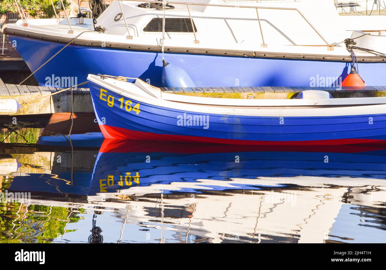 Den Helder, Netherlands. July 2022. Reflection in the water of a small fishingboat. High quality photo Stock Photo