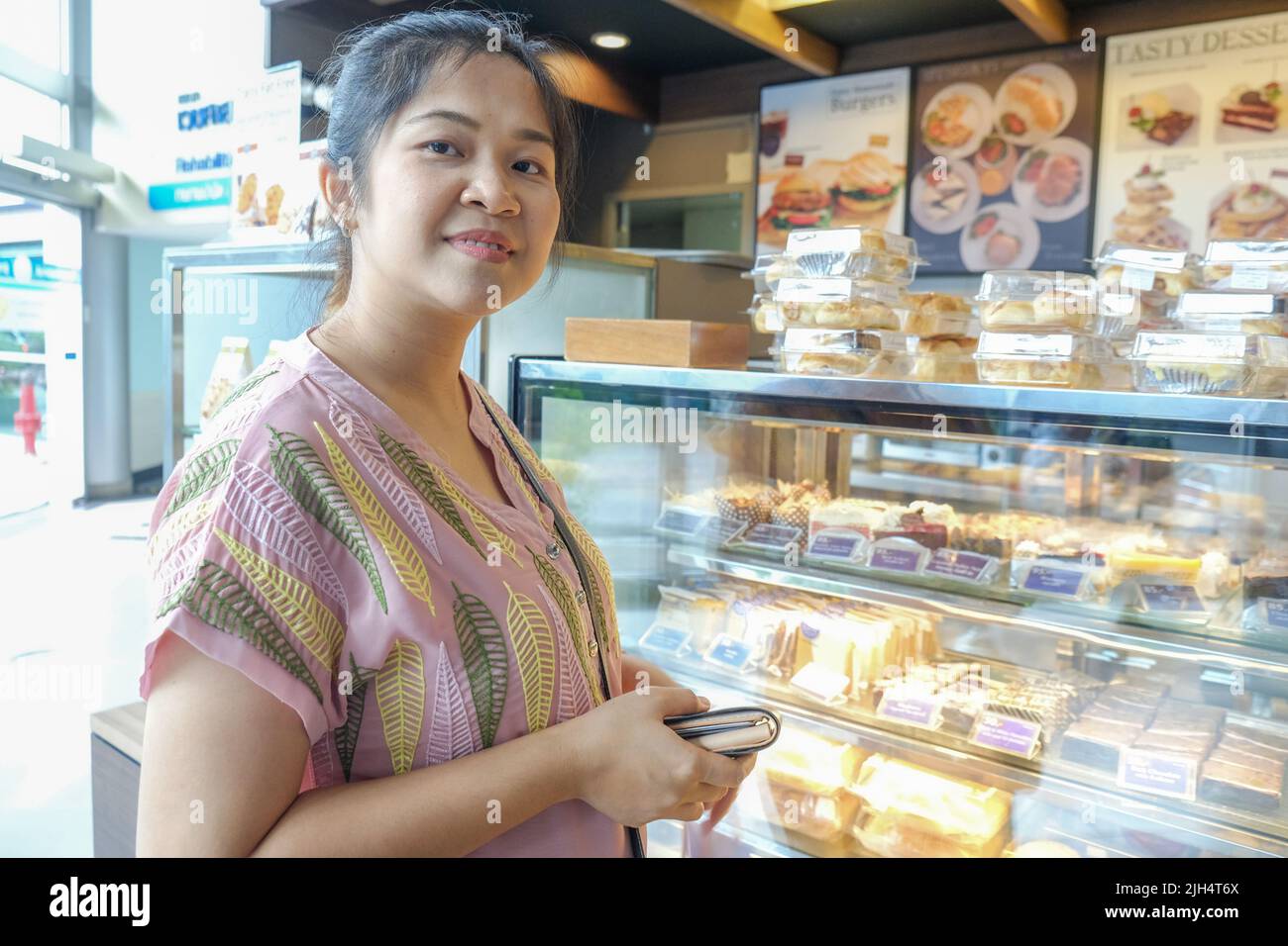 Young asian woman choosing sweet products at grocery supermarket ...