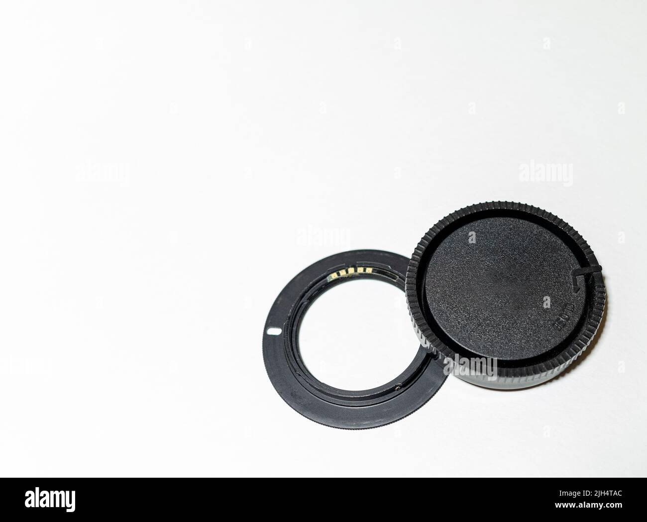 lens adapter and cap on a white background. Copy space. Stock Photo