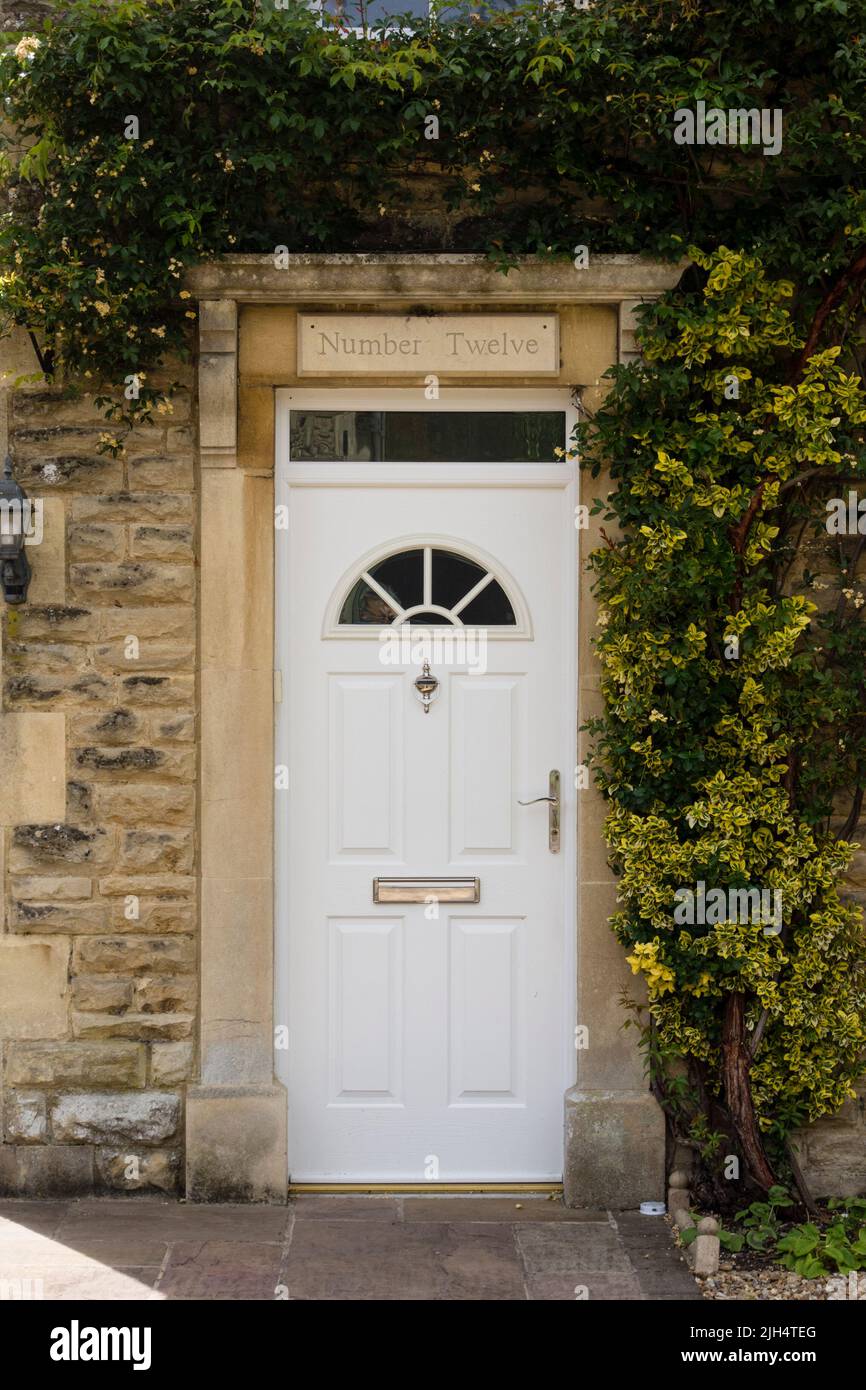 White cottage front door, Tetbury, Gloucestershire, UK Stock Photo