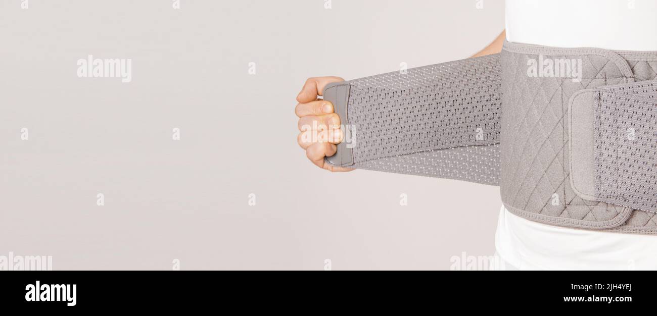 Lumbar brace on the human body isolated on a white background. Trauma