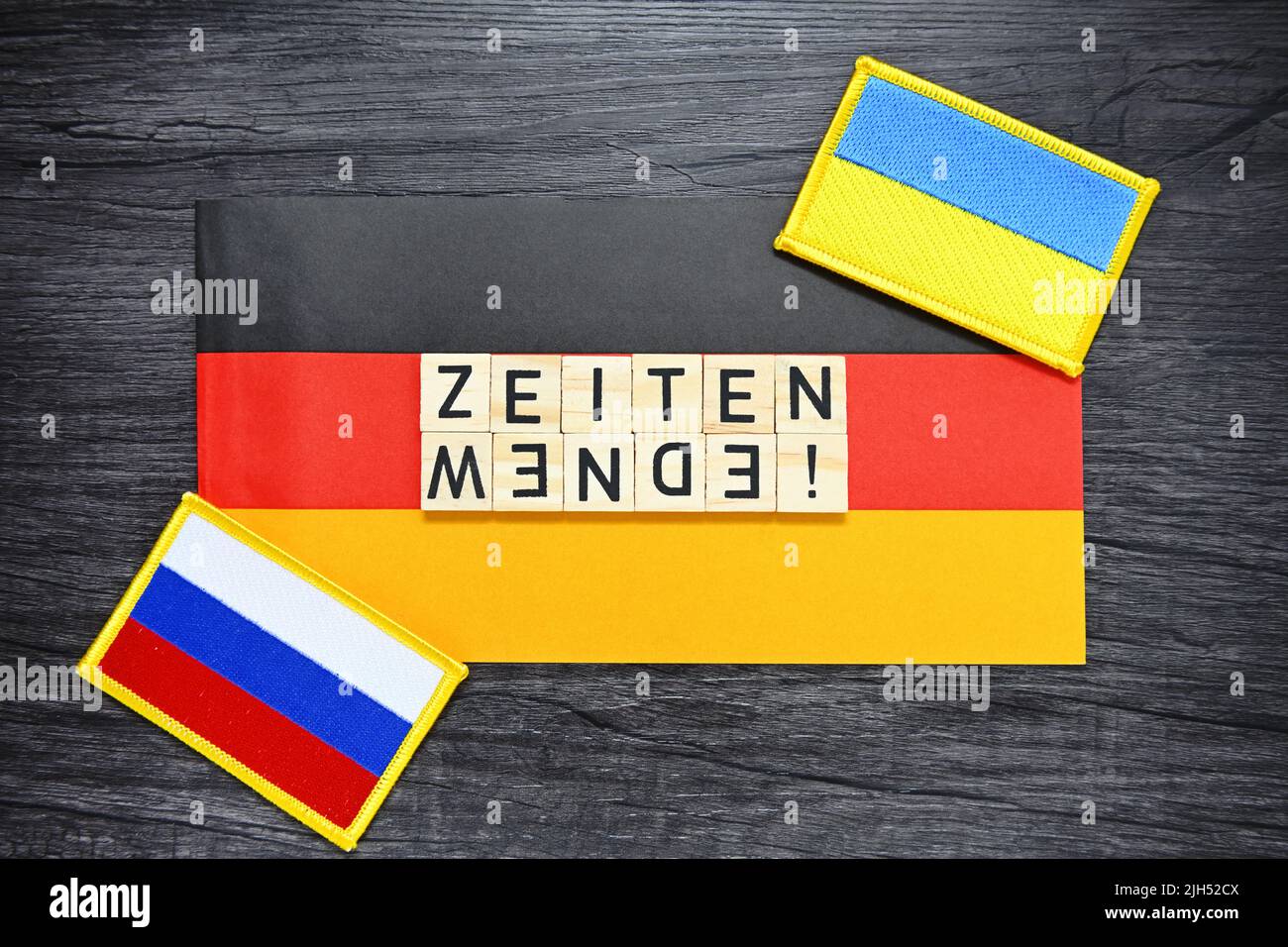 Letter Tiles Forming The German Word For Turning Point In Time On The Flag Of Germany Stock Photo