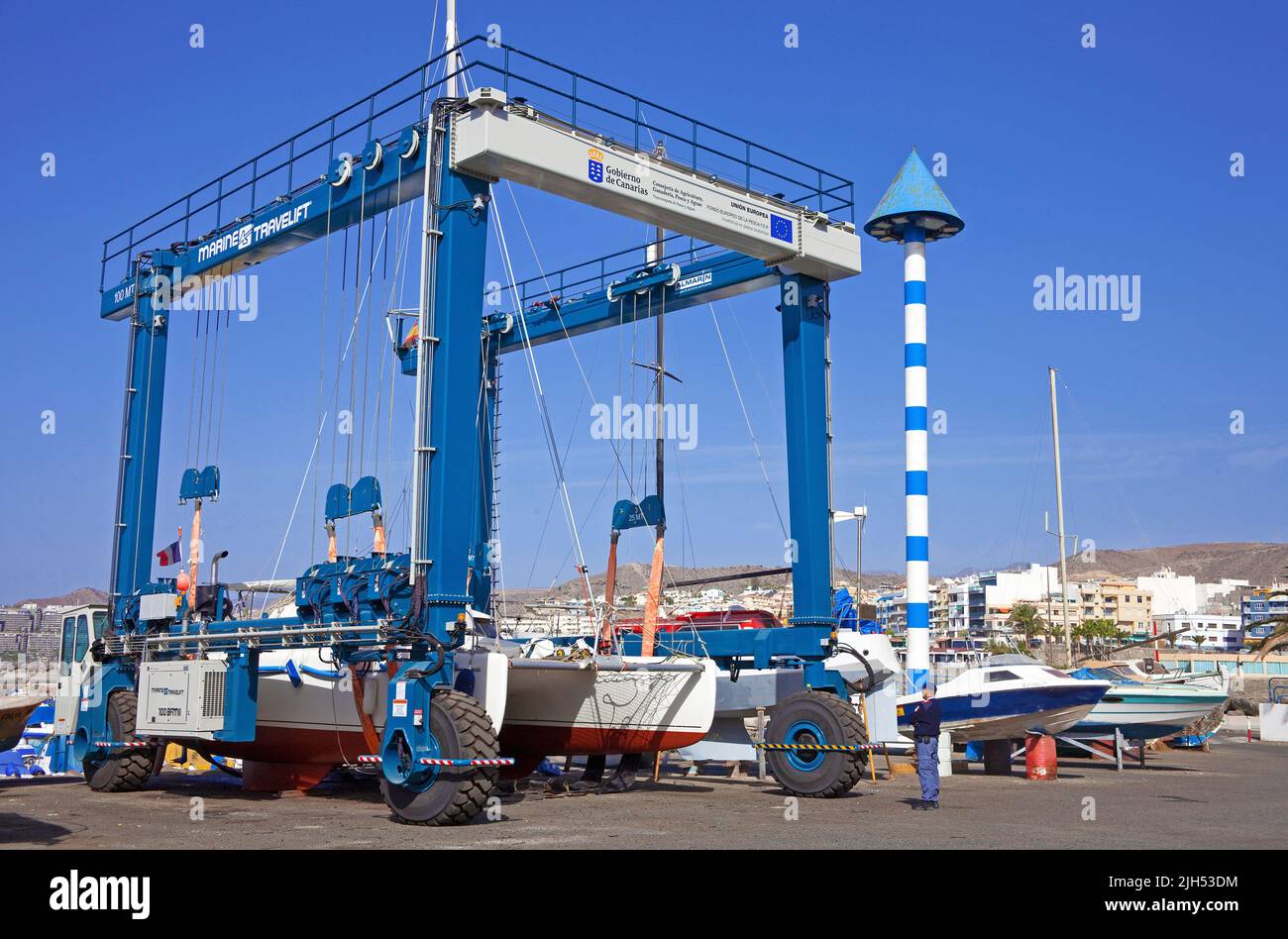 Catamaran in a boat crane, harbour of Arguineguin, Grand Canary, Canary islands, Spain, Europe Stock Photo