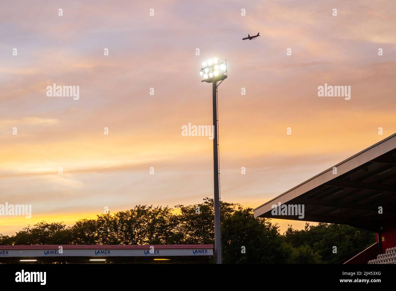 Floodlight at football match set in summer evening sky. Stock Photo