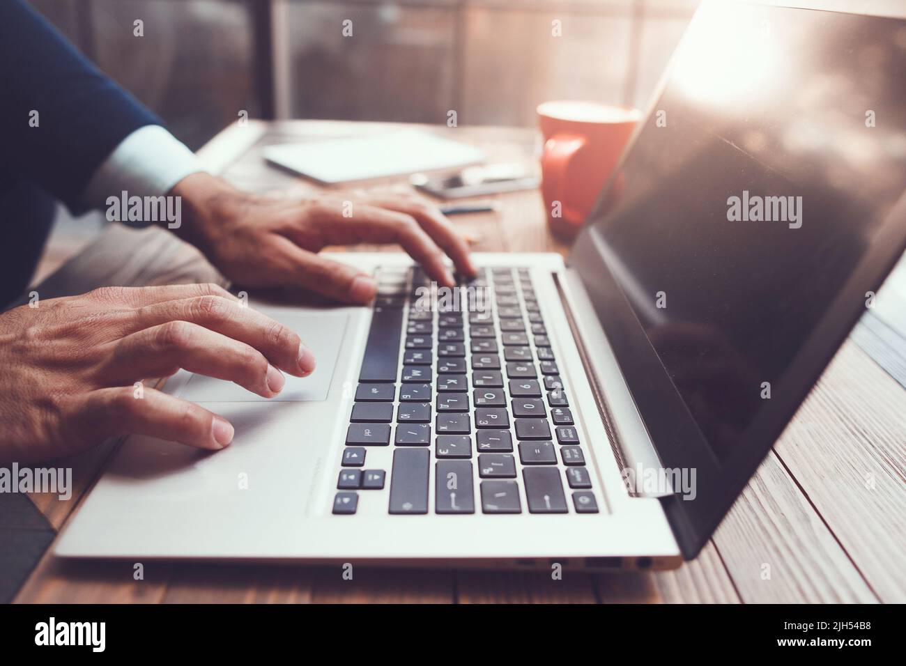 Male hands typing. Modern laptop on desk Stock Photo