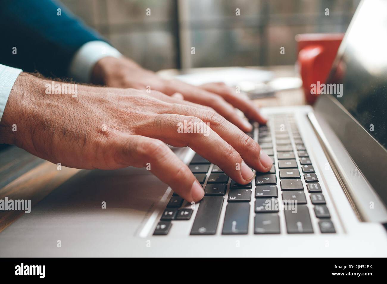 Opened laptop and male hands typing Stock Photo