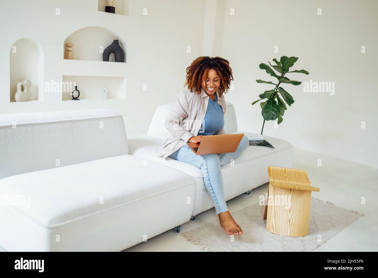 Overjoyed young african american woman, celebrating winning online lottery or reading email with amazing unbelievable news or getting dream job offer. Stock Photo