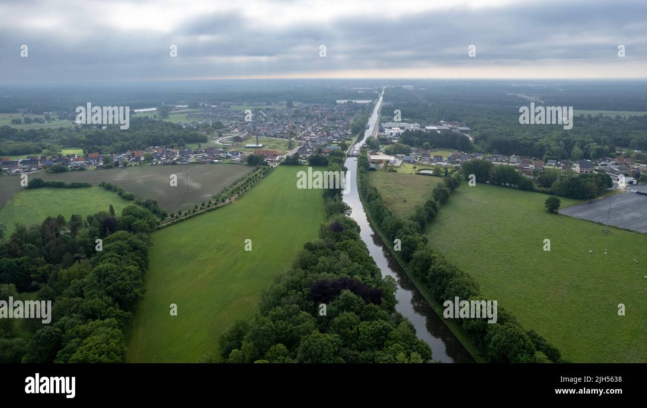 Rijkevorsel, Belgium, 14th of april, 2022, Little village of Sint Jozef, on the canal Dessel Schoten aerial photo in Rijkevorsel, kempen, Belgium, showing the waterway in the natural green agricultural landscape. High quality photo. High quality photo Stock Photo