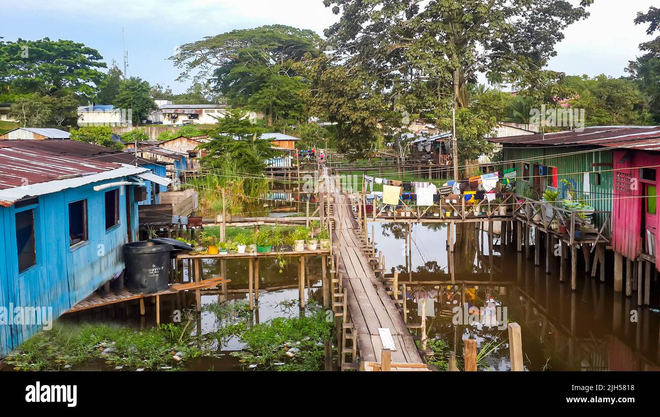Puerto Narino, Colombia - Feb. 13, 2017: Top view on poor housing. Favela slums of local Indian tribes in Amazons. Stilt houses built on piles Stock Photo