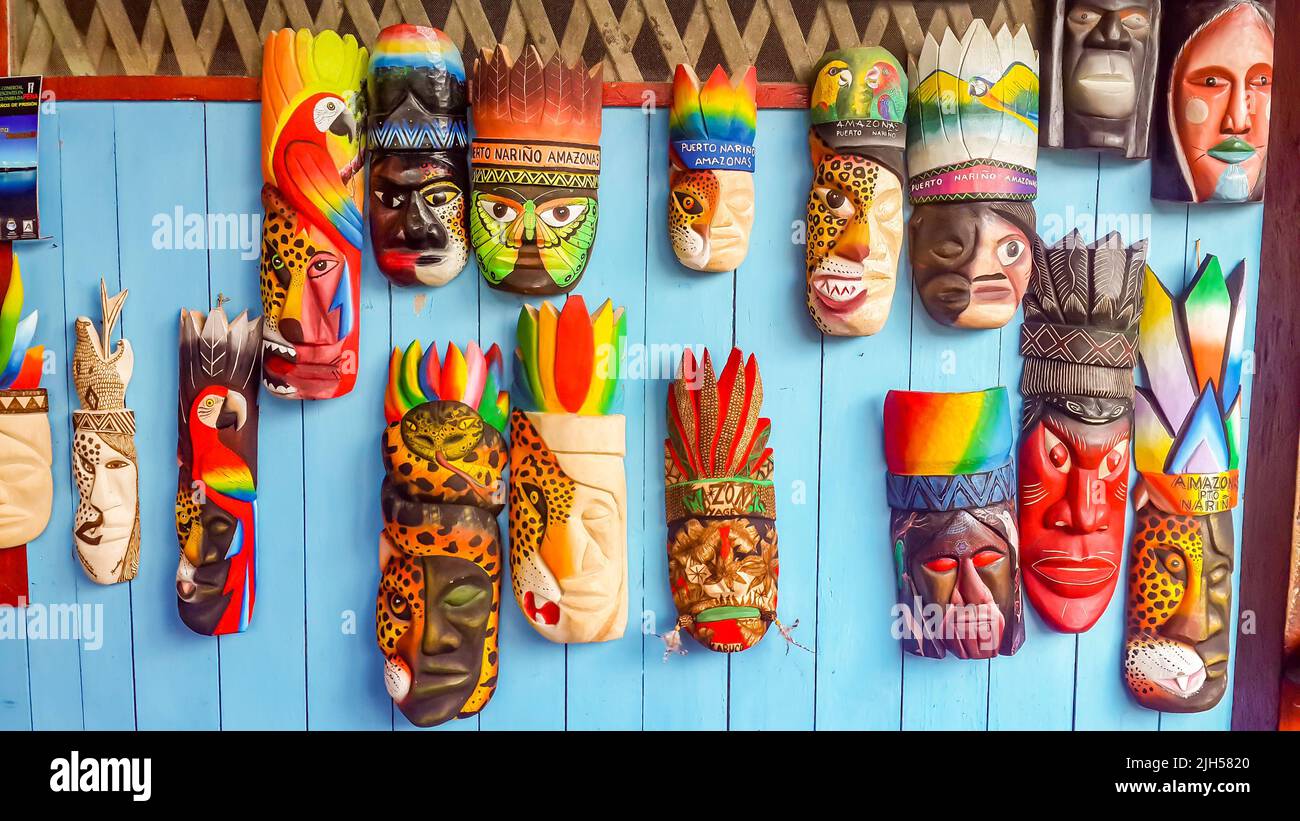 Puerto Narino, Colombia - Feb. 15, 2017: Mayan wooden masks for sale at local village market in Leticia. Colorful native handmade Latin art craft Stock Photo