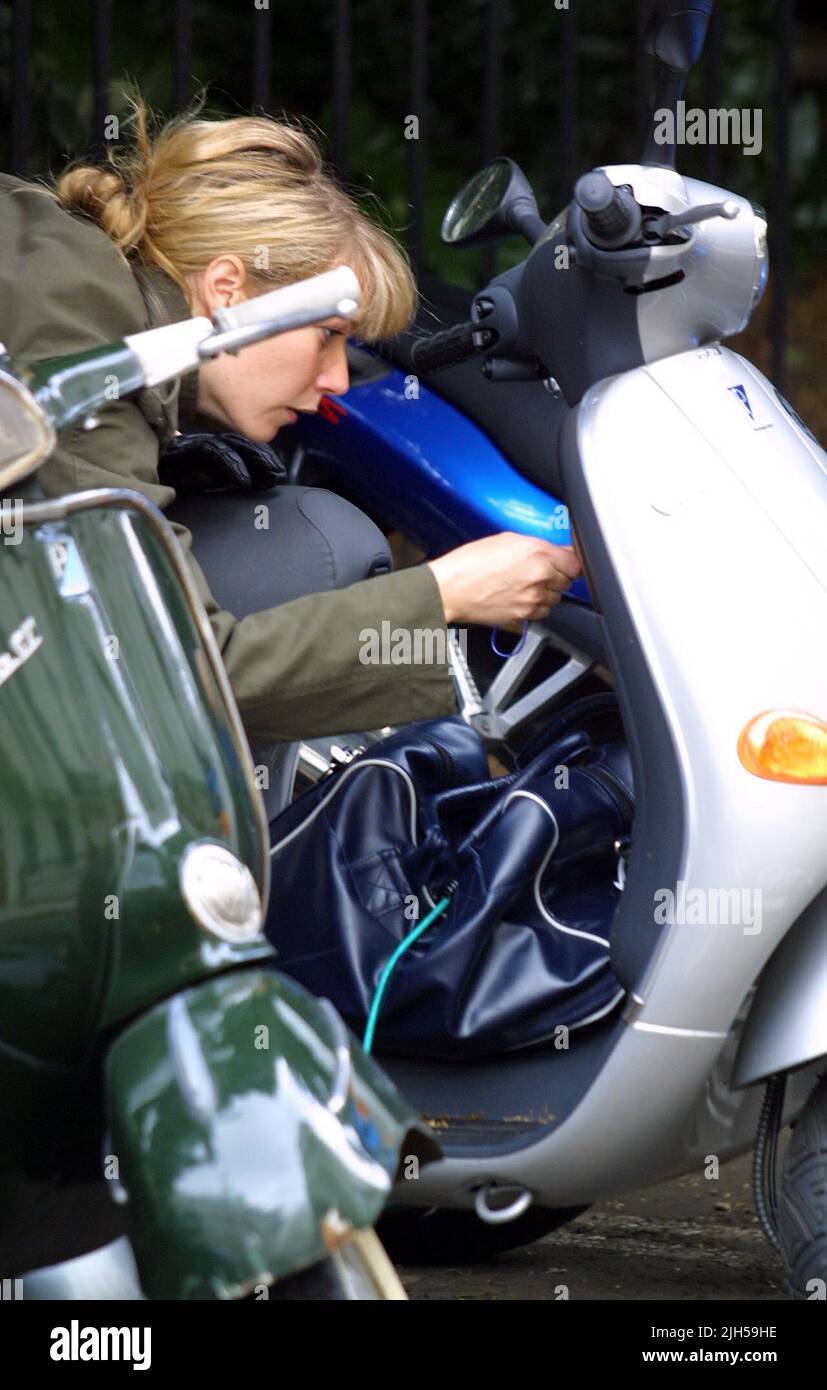 EASY RIDER! Resourceful American Actress GWYNETH PALTROW solves the problem of where to put her sports bag after discovering the space in the seat of her Scooter is too small.  Photo by Tony Henshaw Stock Photo