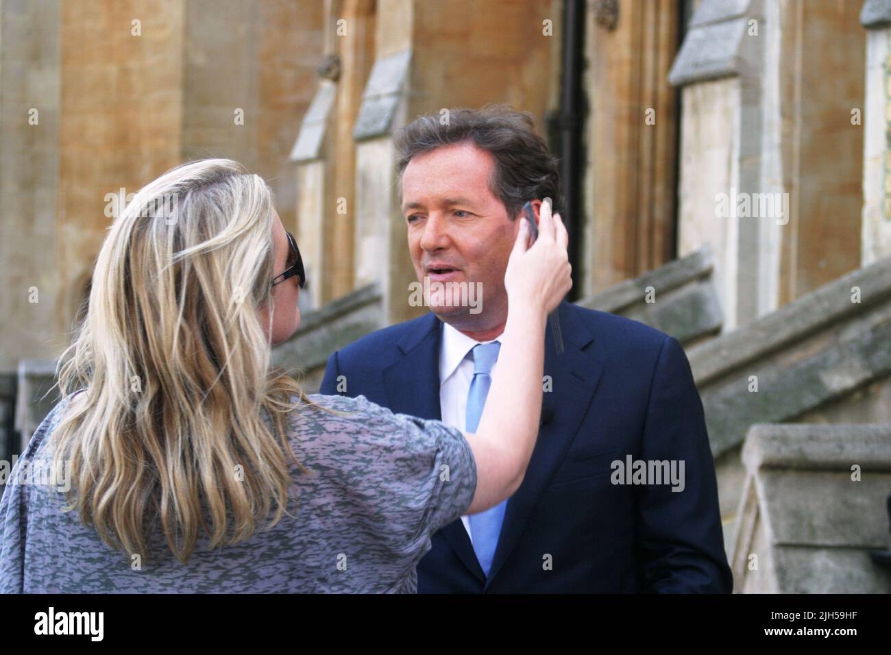 Piers Morgan prepares with some make-up for the for the Royal wedding of William and Kate infront of Westminster Abbey. His regal look was helped with make up and he said 'let me get you to the church on time..' Picture by Tony Henshaw Stock Photo