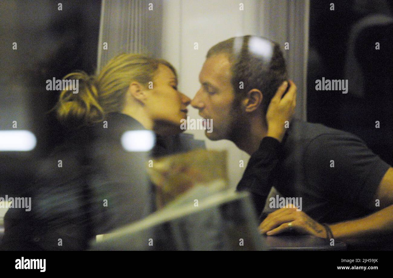 **EXCLUSIVE**PICTURES** American Actress Gwyneth Paltrow closes her eyes and pulls Coldplay's Chris Martin, toward her for a lingering kiss. The pair were spotted on board a first class carriage of the 'Gatwick Express' train, from London Victoria to the airport. The couple were lightly packed and now that neither has any immediate work commimtments, could they be off to start the family Gwyneth reportedly wants? Stock Photo