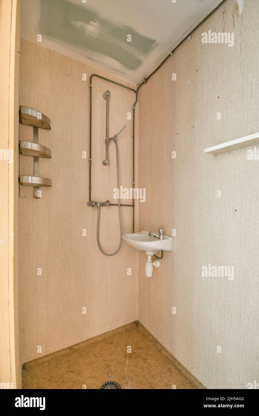 Glass partition between shower tap and wall hung toilet in modern