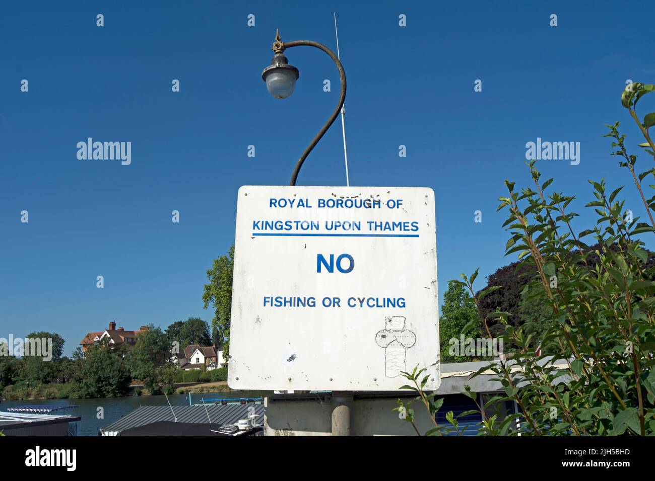 alongside the river thames, a royal borough of kingston upon thames sign warning no fishing or cycling, kingston, surrey, england Stock Photo