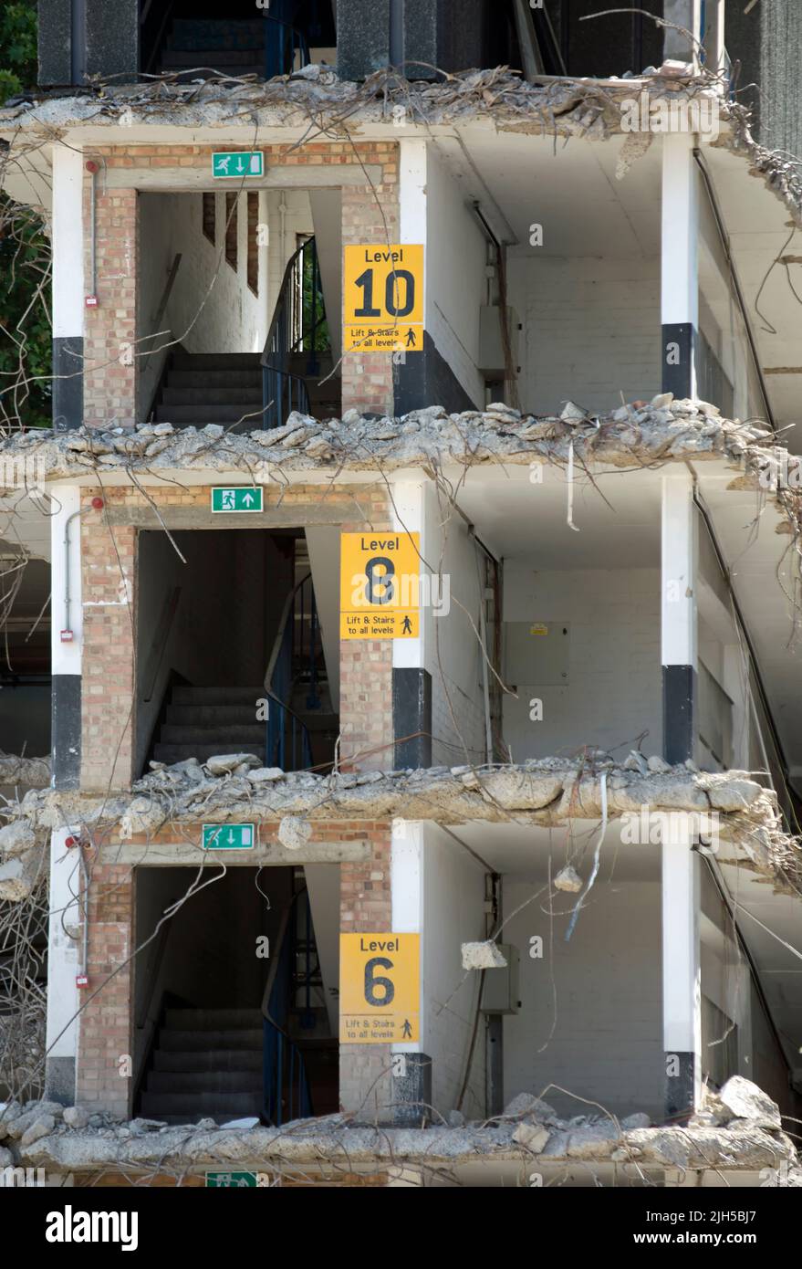 a partially demolished multi-storey car park in kingston upon thames, surrey, england, still showing signs for levels, stairs and lifts Stock Photo