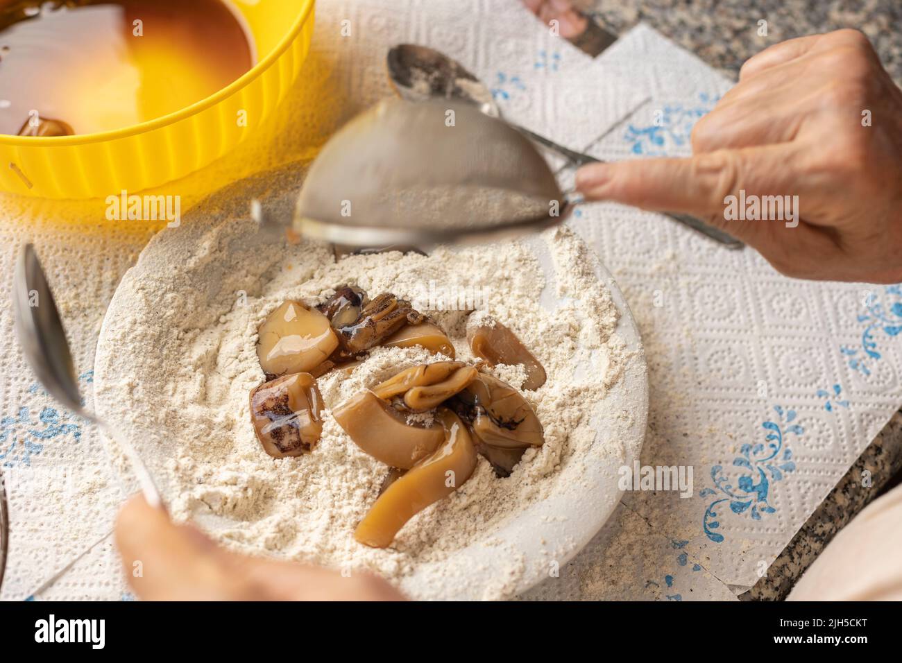 Fish breading for frying, food preparation home made. Squid breading