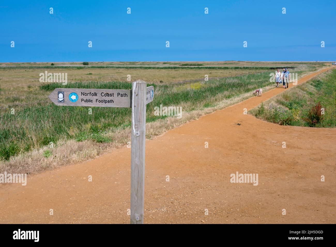 North Norfolk Coast Path, view in summer of people walking the North Norfolk Coast Path near Cley in Norfolk, England, UK Stock Photo