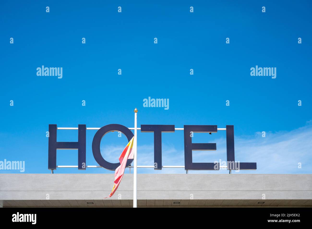A Repsol hotel advertising sign at a service area in Spain against a colourful blue sky Stock Photo
