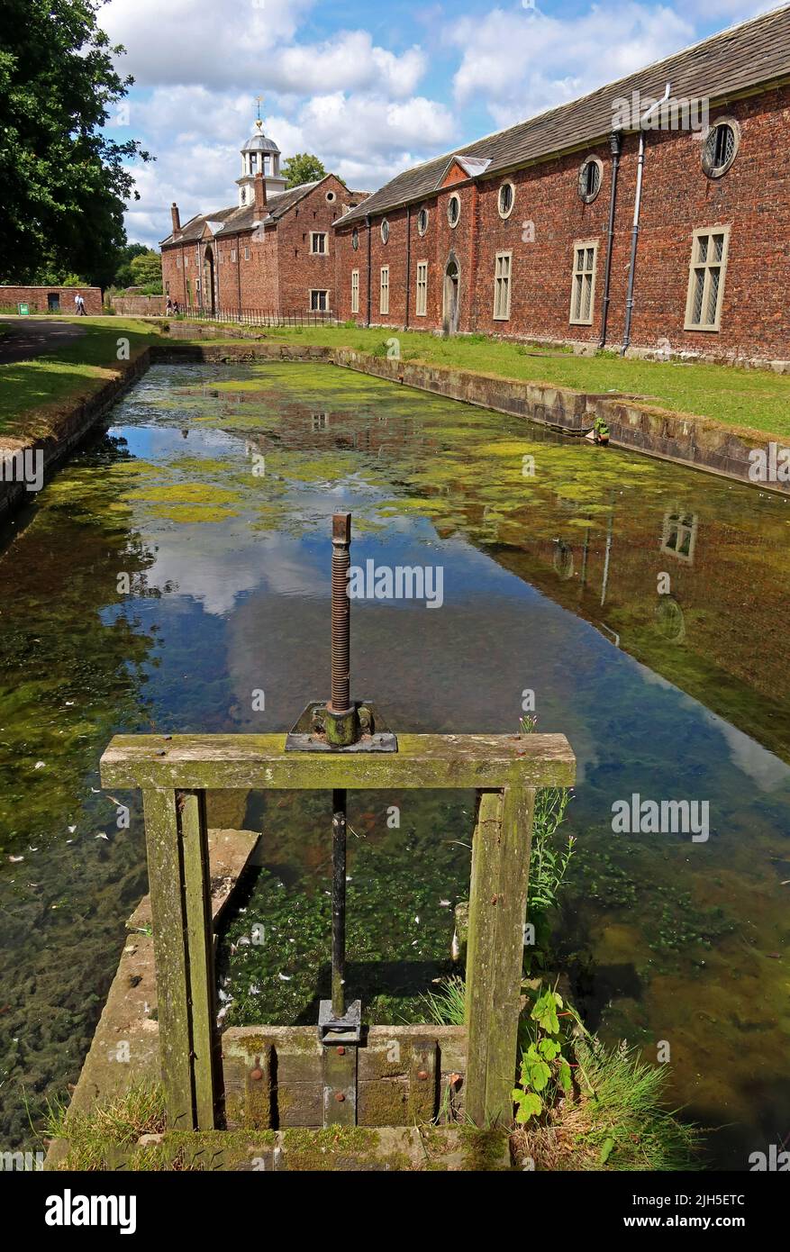 Dunham Massey, NT hall , moat, sluice  and gardens, Dunham town, Bowden, Altrincham, Cheshire, England, UK,  WA14 4SJ Stock Photo