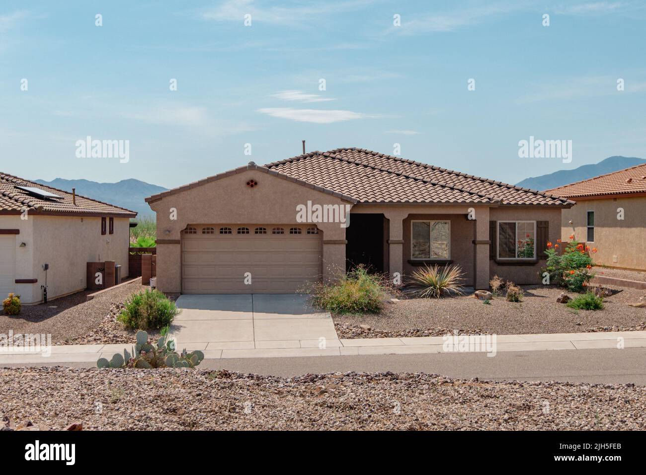 Street view of a suburban home with xeriscape landscaping. Stock Photo